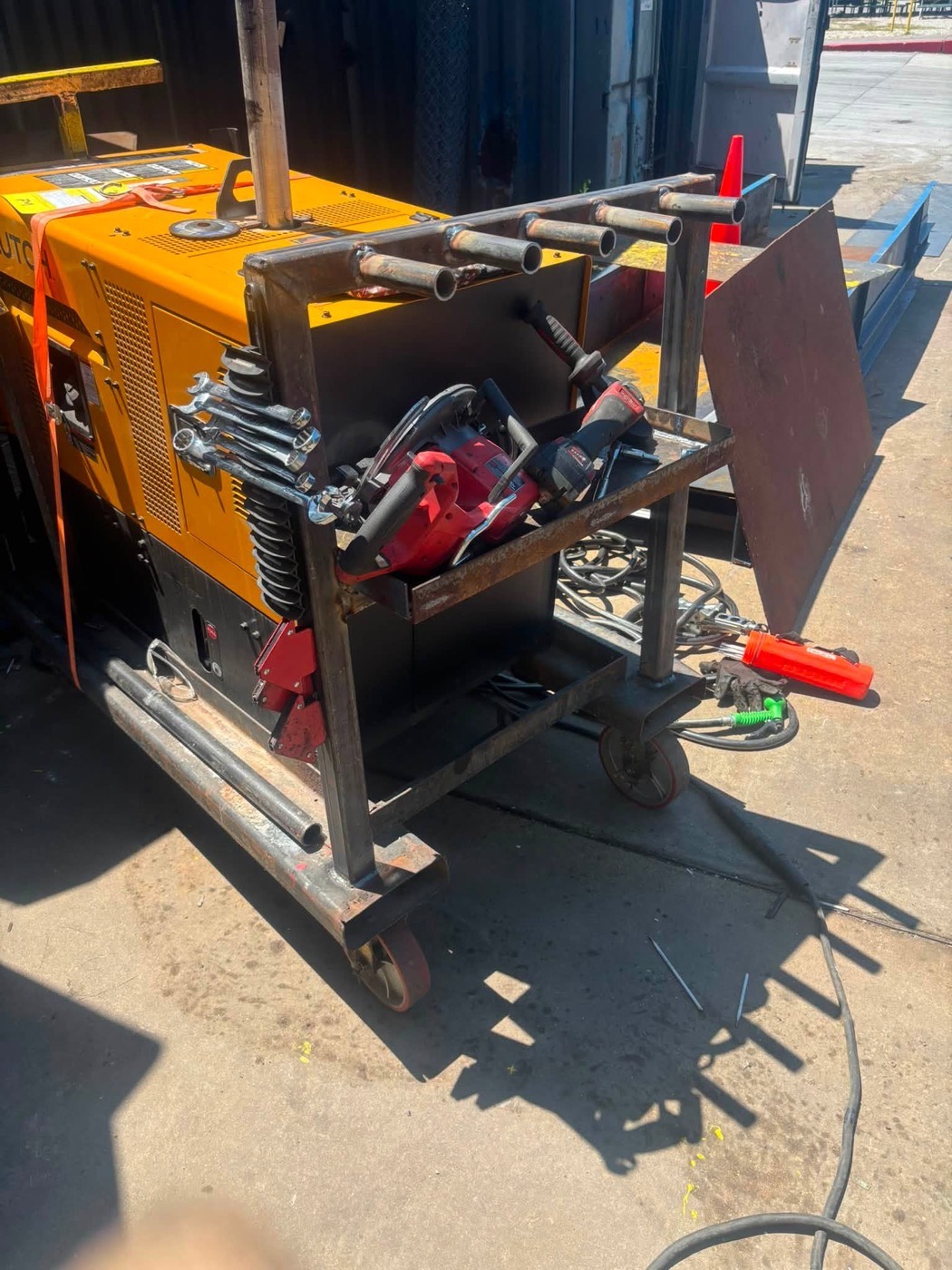 Custom welded tool tray on the mobile rig holding saw and drill