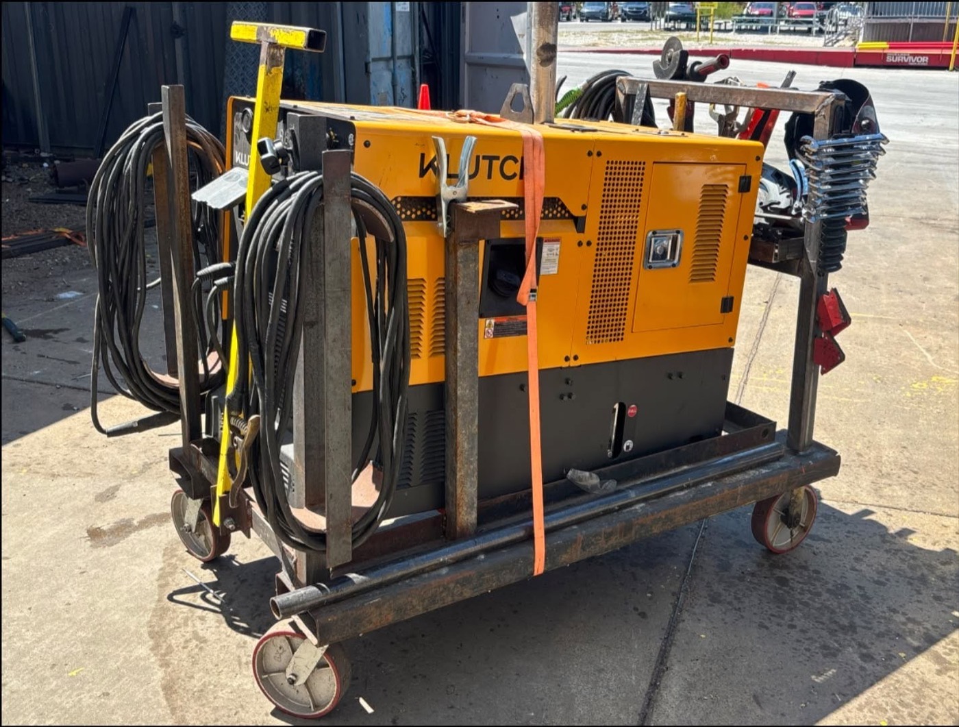 Front view of the mobile welding cart with grinders and clamps racked